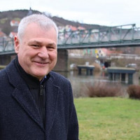 SPD-Bürgermeisterkandidat Jürgen Keller vor der Brücke, die Retzbach und Zellingen verbindet.